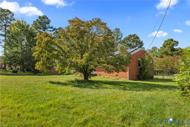 a view of a field of grass and trees
