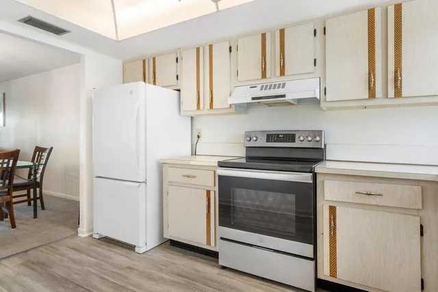 a white refrigerator freezer sitting inside of a kitchen