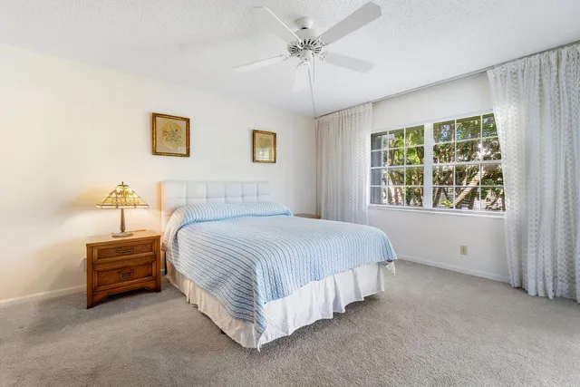 a spacious bedroom with a bed and a window