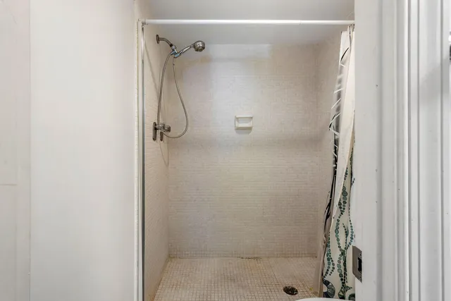 a bathroom with a glass shower door