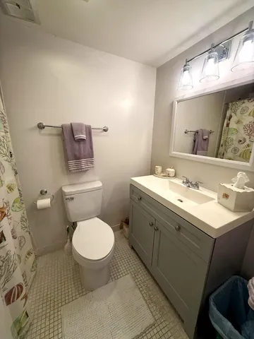 a bathroom with a sink toilet and a mirror