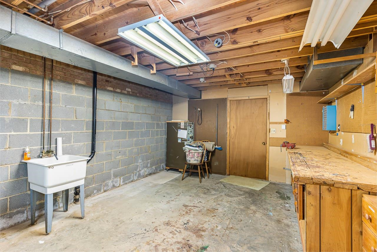 8600 Lawn Court Raleigh, NC 27613 - Photo 30 of 31 Large workshop area with workbench and utility sink. Workshop