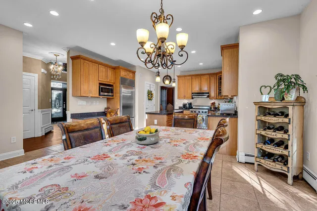 a kitchen with a table chairs refrigerator and microwave