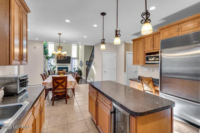 a living room with furniture a fireplace a flat screen tv and a large window