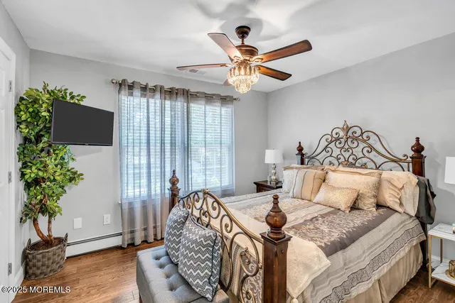 a spacious bedroom with a bed and a chandelier