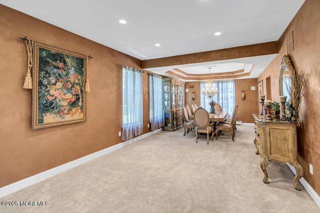 a view of a dining room with furniture wooden floor and chandelier
