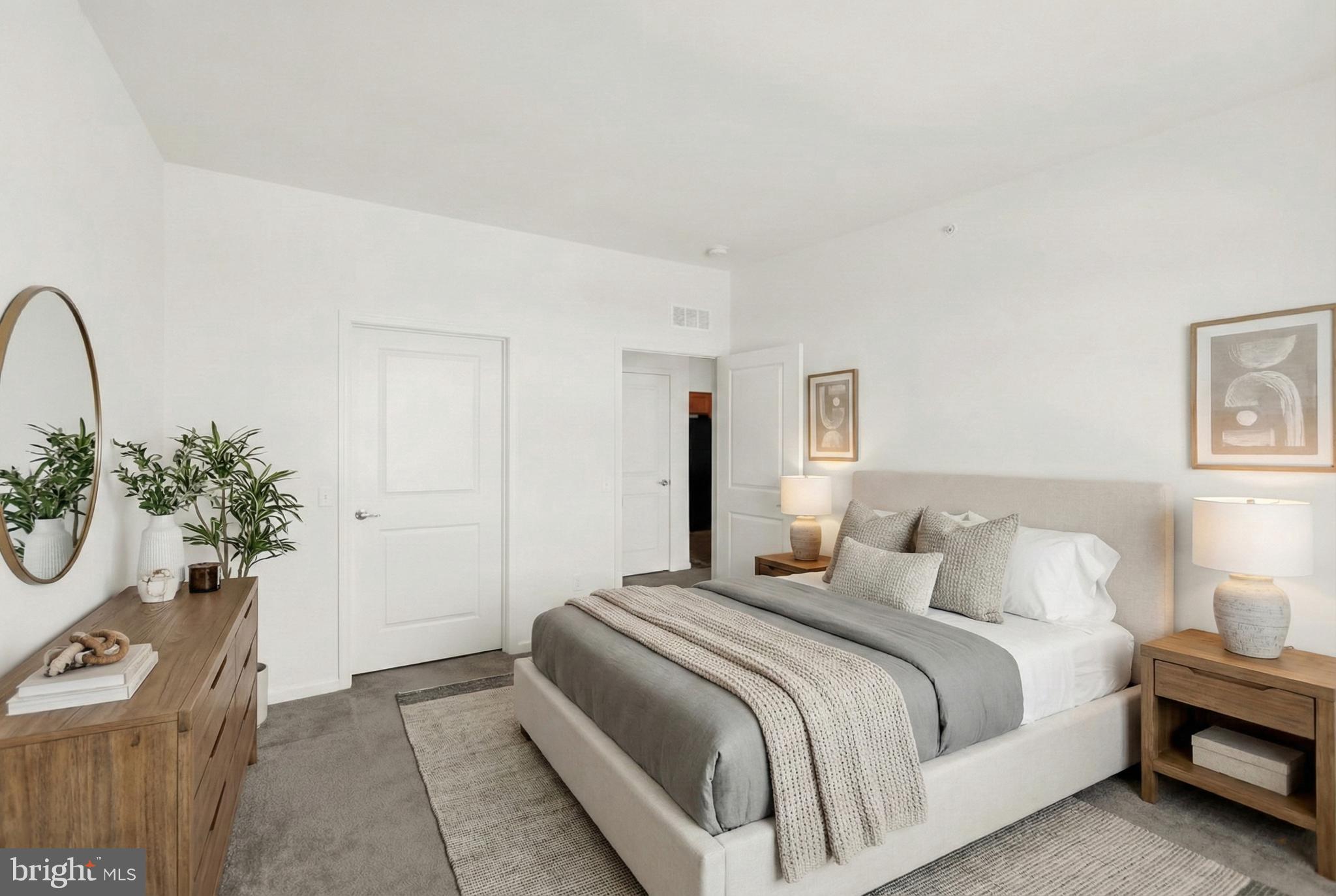 113 Legacy Boulevard, Unit 106 Sinking Spring, PA 19608 - Photo 5 of 9 a bedroom with a bed and a potted plant