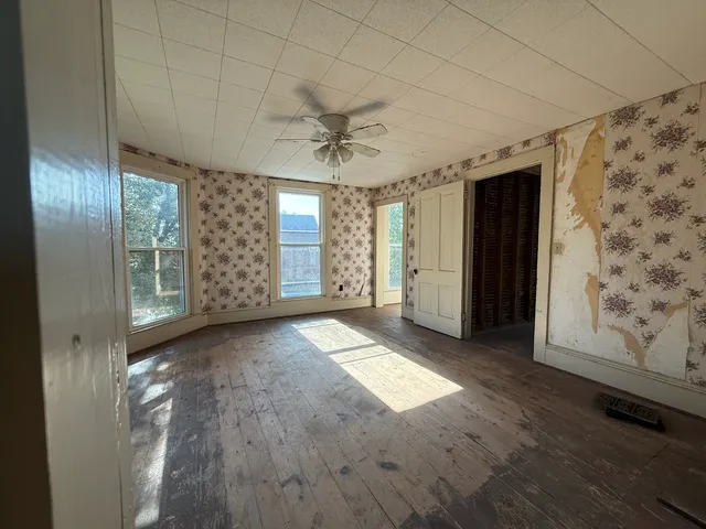 an empty room with windows and closet