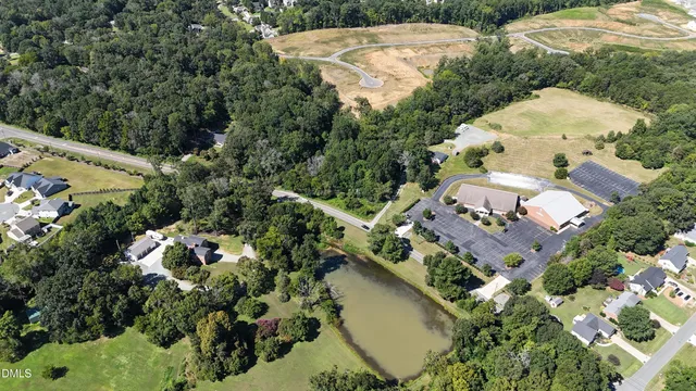 an aerial view of a house with a yard and lake view