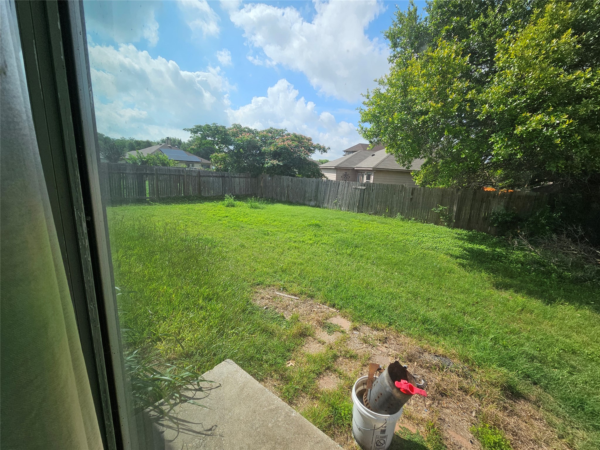1120 Apollo Circle Round Rock, TX 78664 - Photo 14 of 14 A generous backyard, fully fenced for privacy and bordered by mature trees, provides ample space for outdoor activities.