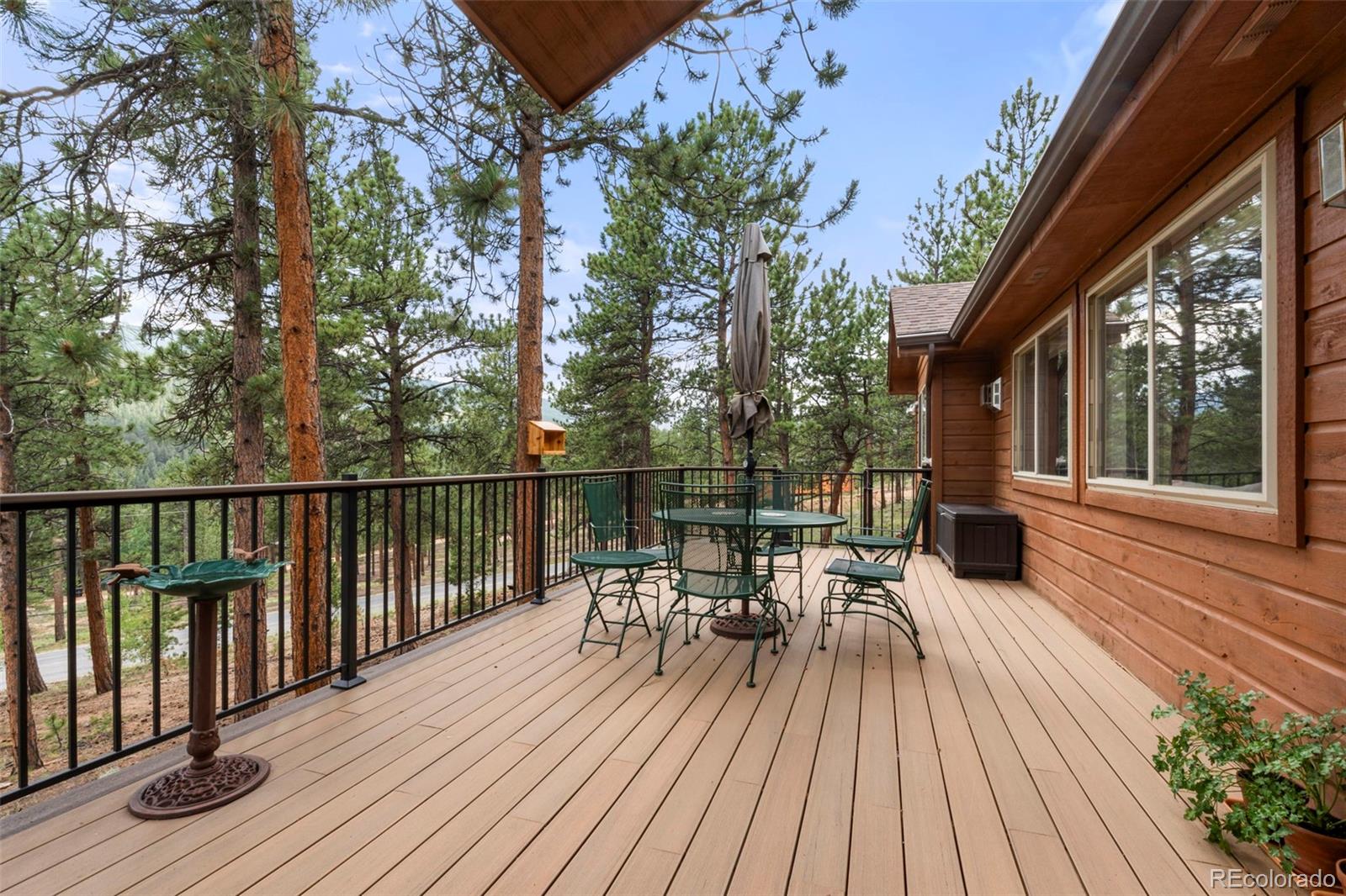 84 Marys Lane Bailey, CO 80421 - Photo 25 of 35 a view of a roof deck with table and chairs wooden floor and fence