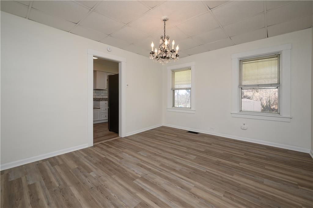 2606 Belmar Place Pittsburgh, PA 15218 - Photo 6 of 27 a view of empty room with wooden floor and chandelier