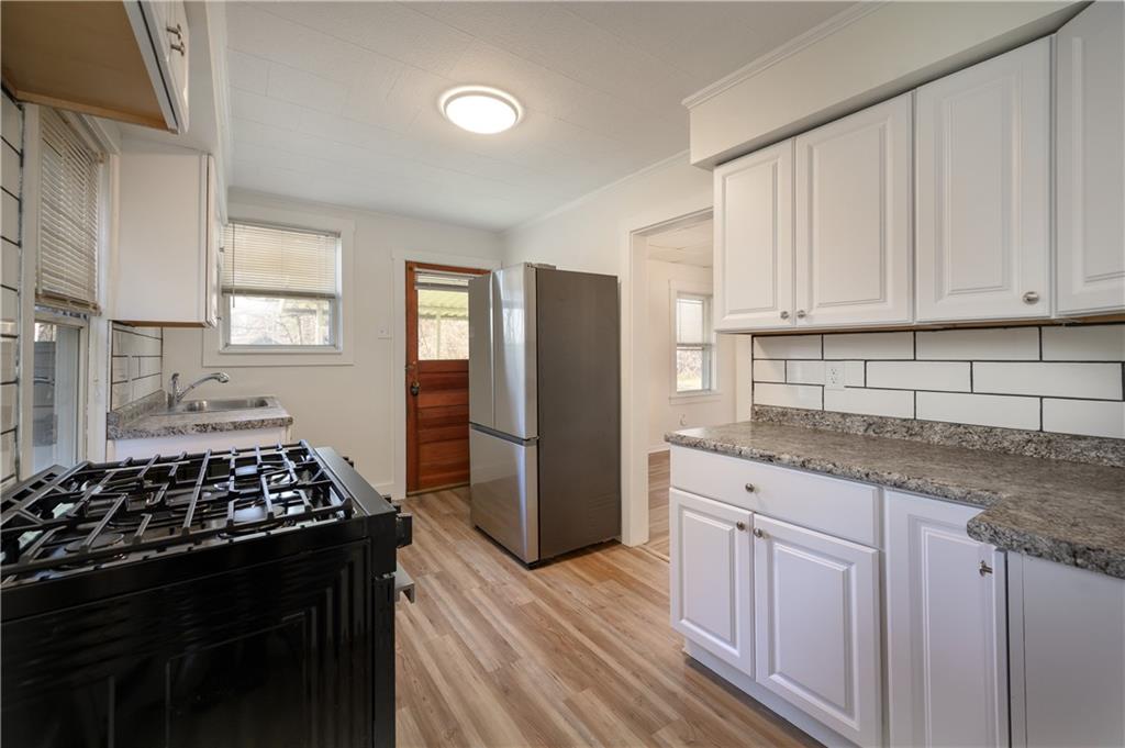 2606 Belmar Place Pittsburgh, PA 15218 - Photo 9 of 27 a kitchen with granite countertop a refrigerator stove and sink
