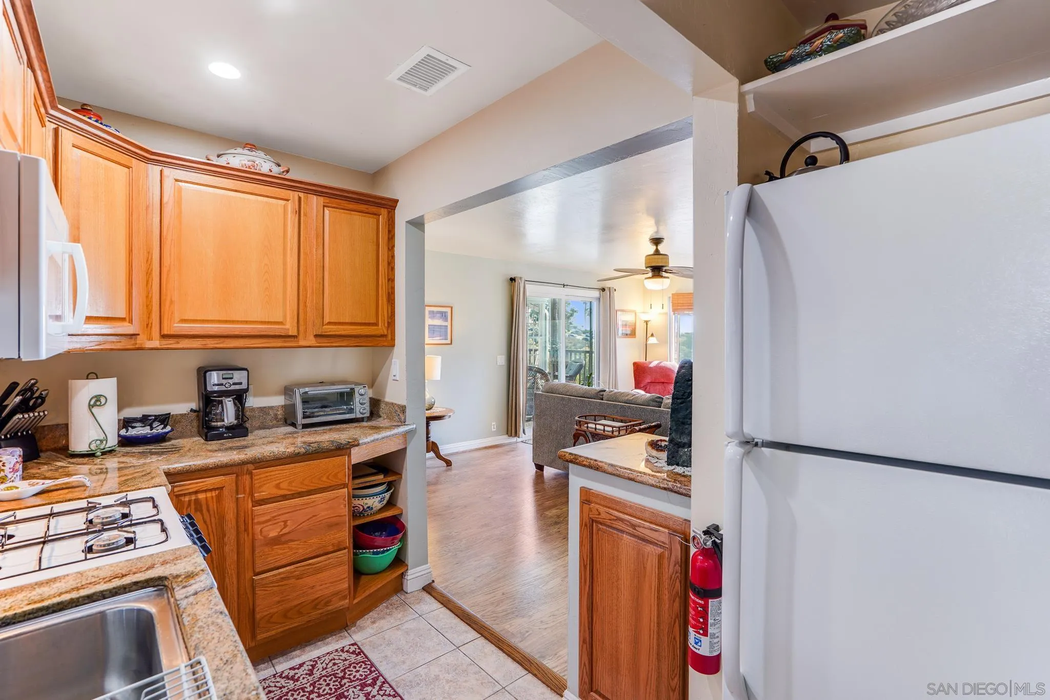 253 B Street Encinitas, CA 92024 - Photo 20 of 61 a kitchen with stainless steel appliances granite countertop a refrigerator sink and wooden cabinets