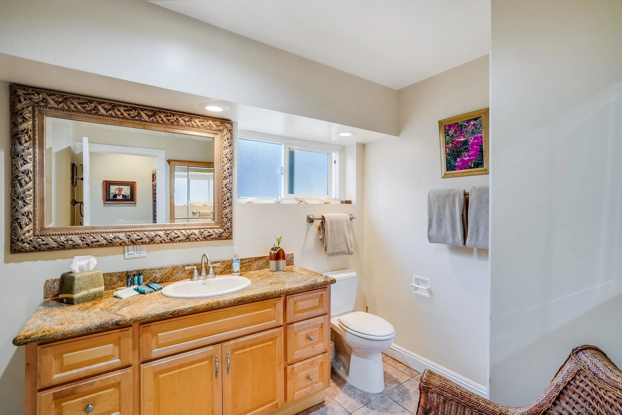 253 B Street Encinitas, CA 92024 - Photo 21 of 61 a bathroom with a granite countertop toilet sink and mirror