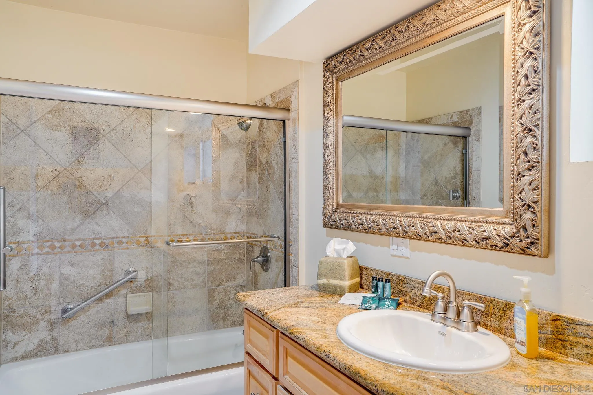 253 B Street Encinitas, CA 92024 - Photo 22 of 61 a bathroom with a granite countertop sink mirror and a shower