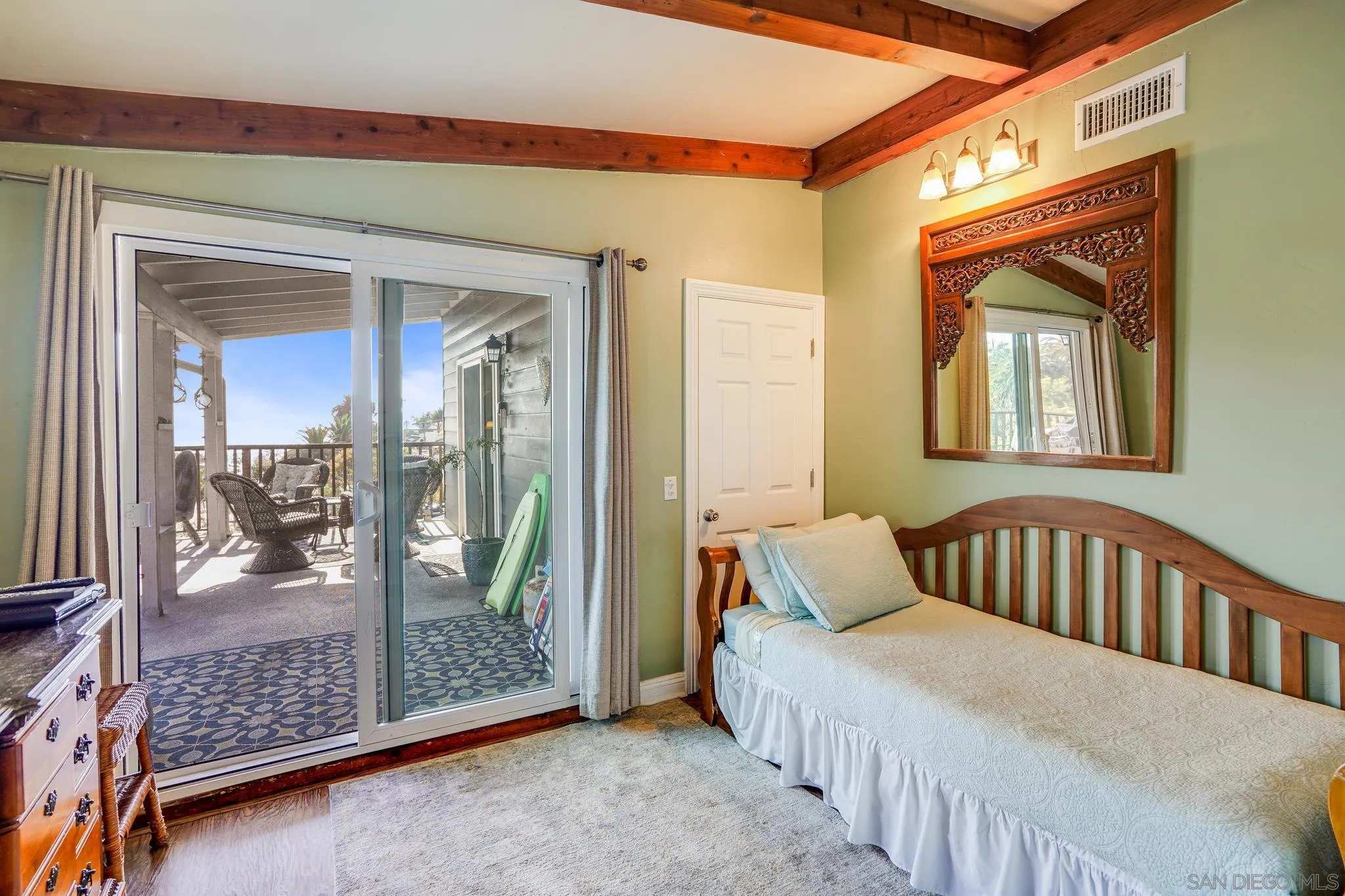 253 B Street Encinitas, CA 92024 - Photo 25 of 61 a bedroom with a bed and glass door