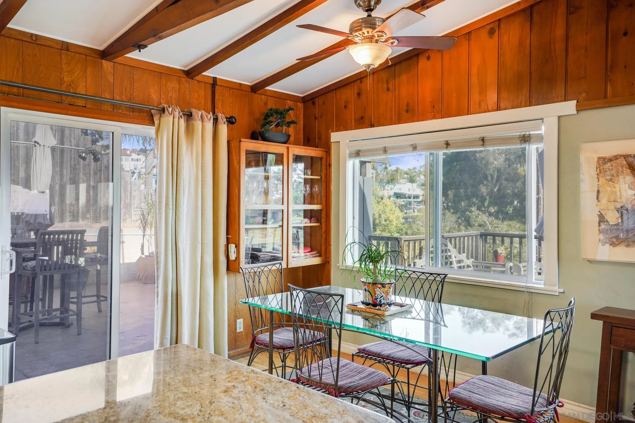 253 B Street Encinitas, CA 92024 - Photo 37 of 61 a dining room with glass top table and chairs