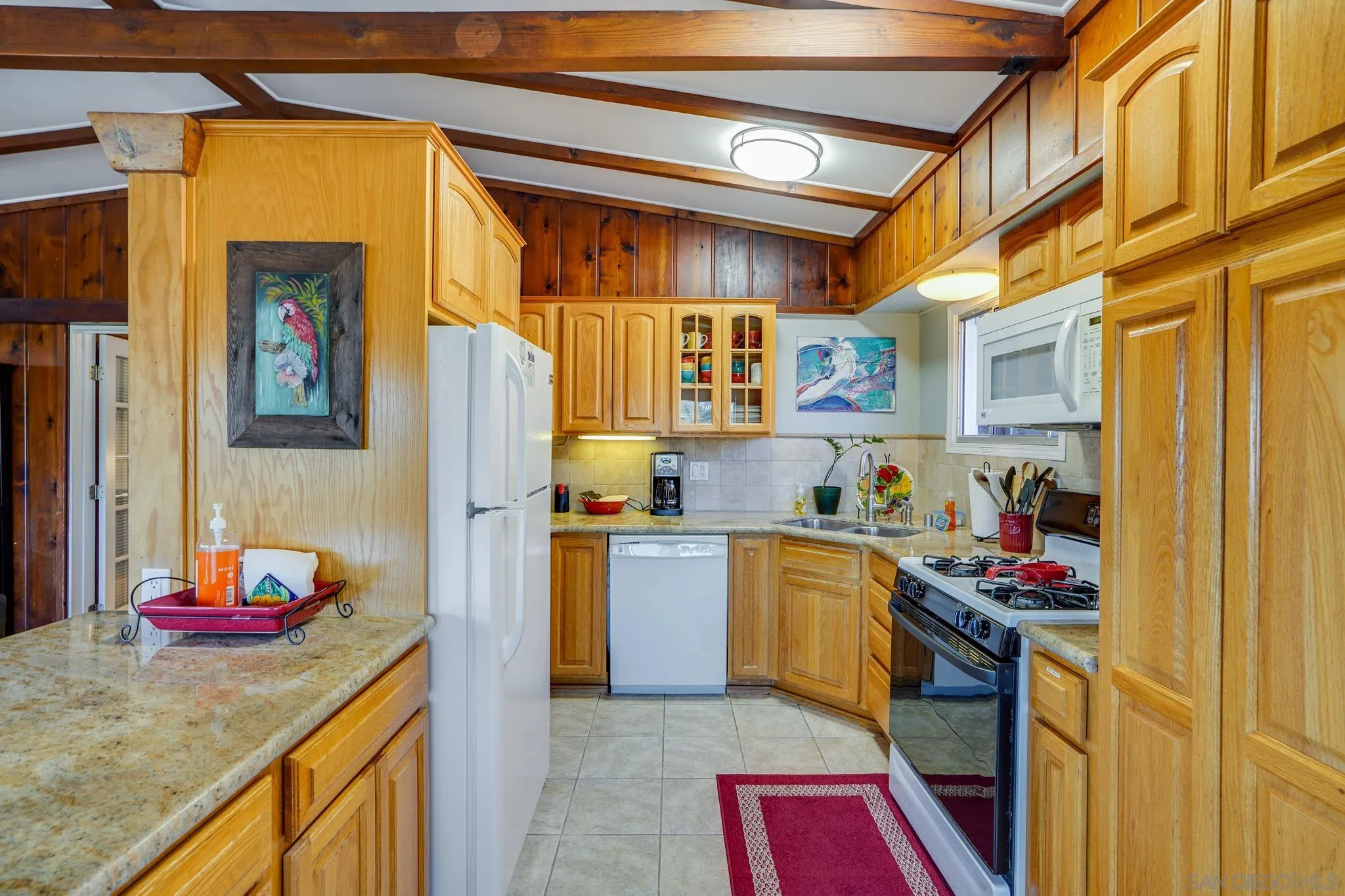 253 B Street Encinitas, CA 92024 - Photo 38 of 61 a kitchen with stainless steel appliances granite countertop a stove and cabinets