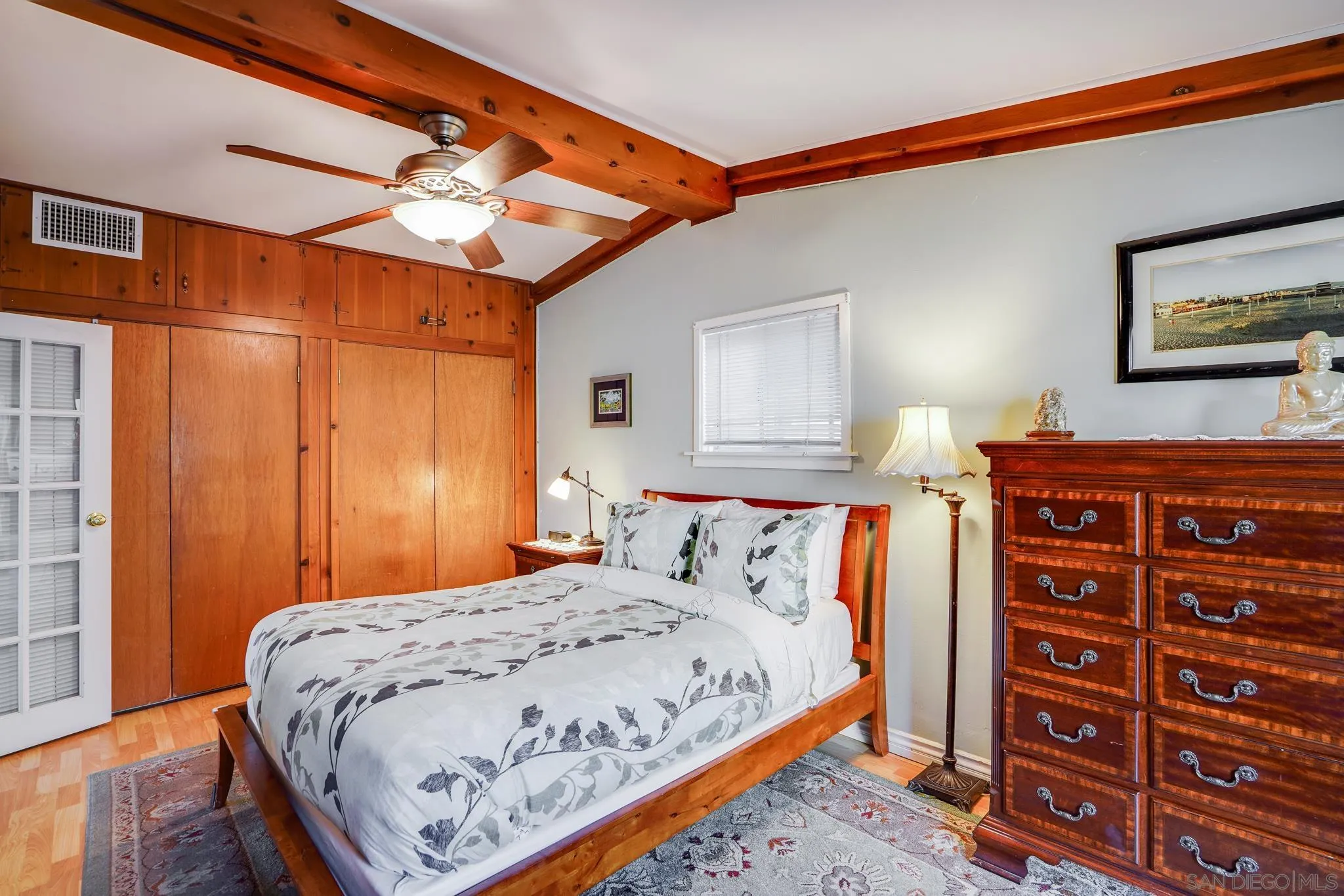 253 B Street Encinitas, CA 92024 - Photo 44 of 61 a bedroom with a bed and a chandelier