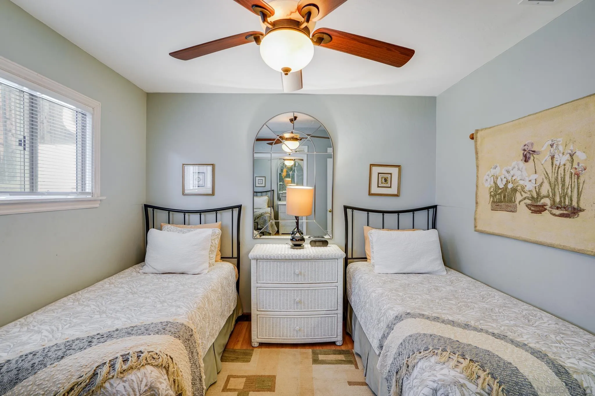 253 B Street Encinitas, CA 92024 - Photo 45 of 61 a bedroom with a bed and a chandelier