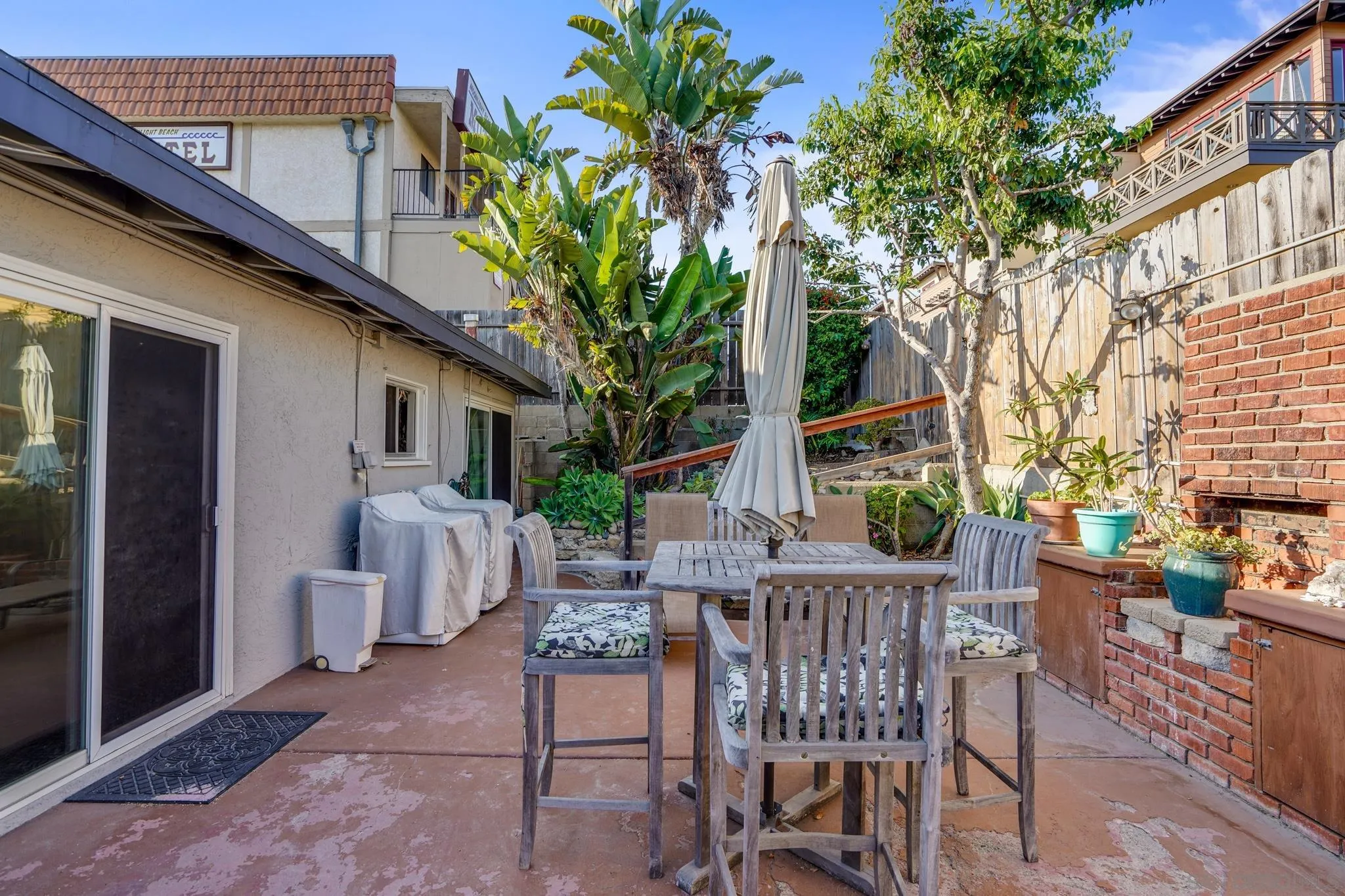 253 B Street Encinitas, CA 92024 - Photo 51 of 61 a view of a patio with table and chairs and potted plants