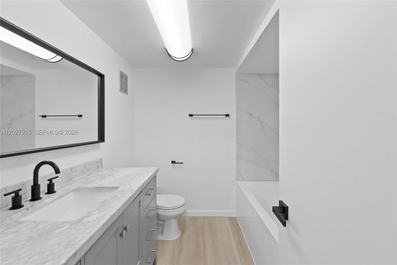 301 Racquet Club Road, Unit 103 Weston, FL 33326 - Photo 8 of 20 a bathroom with a sink and a toilet