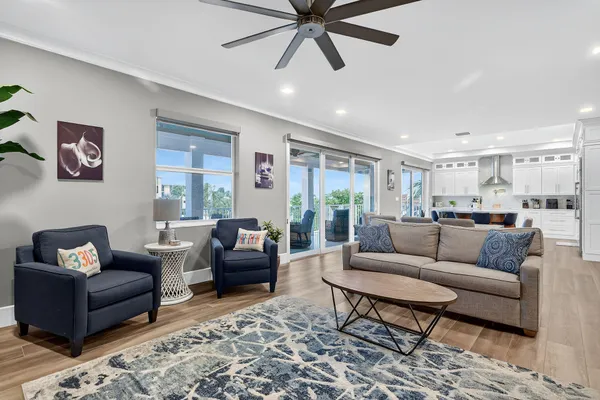 a living room with furniture and a view of kitchen
