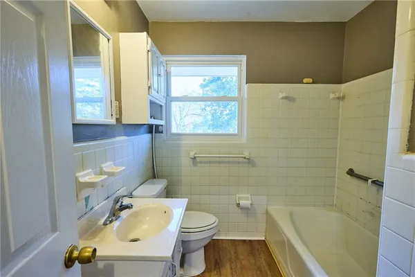 a bathroom with a sink a toilet and tub