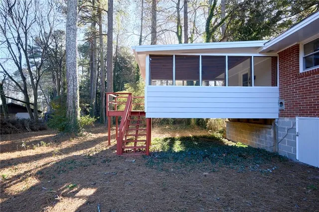 a view of a wooden house with a yard