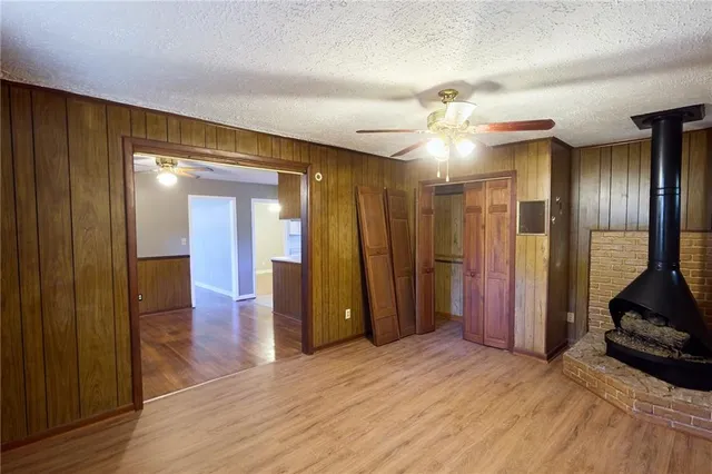 a view of a hallway with wooden floor and a ceiling fan