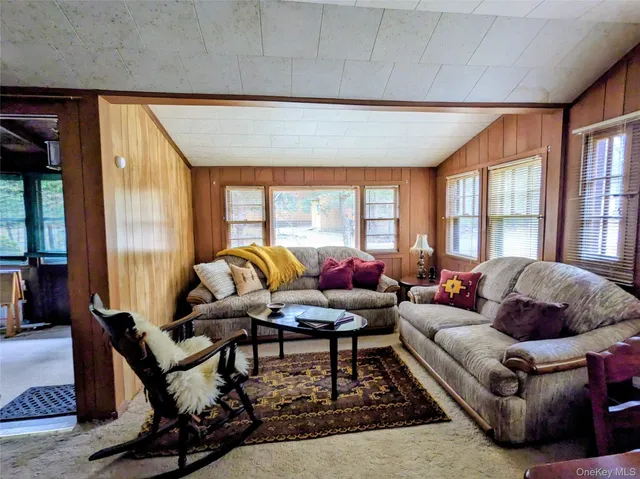 a living room with furniture and a floor to ceiling window