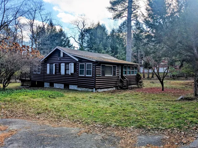 a view of a house with a deck yard and trees