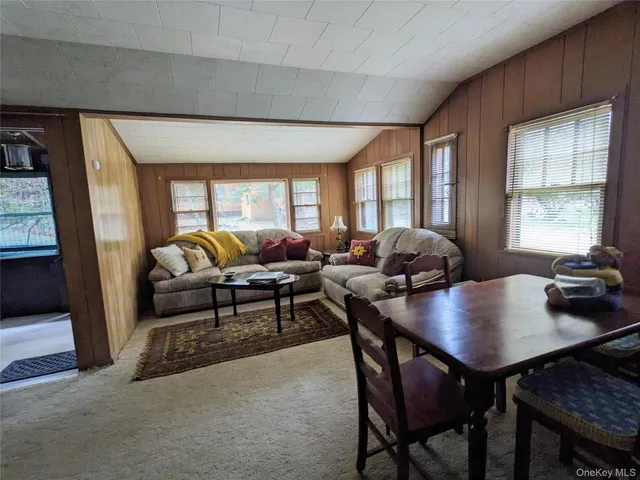 a living room with furniture a wooden floor and a large window