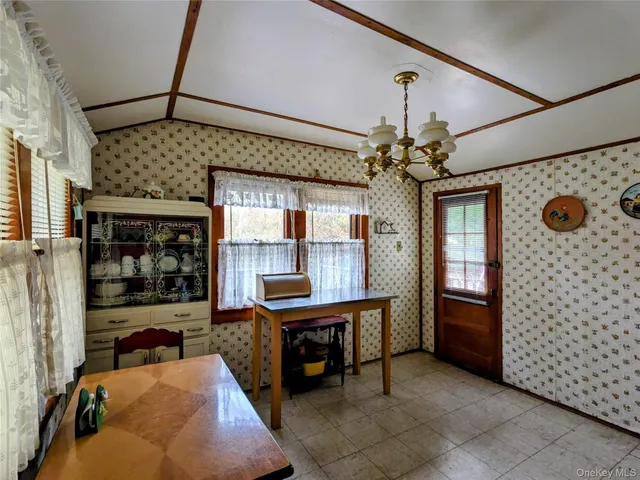 a dining room with furniture and chandelier