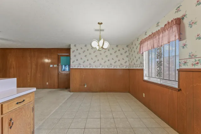 a large kitchen with stainless steel appliances granite countertop a refrigerator and a sink