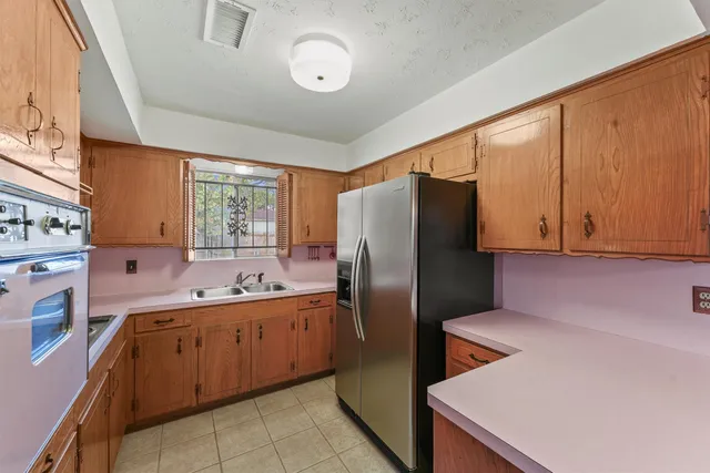 a kitchen with stainless steel appliances a sink a stove and a window