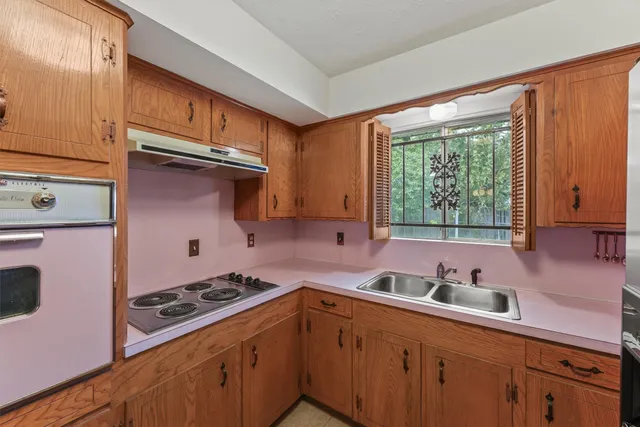 a kitchen with stainless steel appliances a refrigerator and a stove
