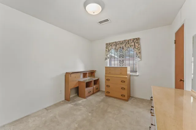 a bedroom with a bed and window