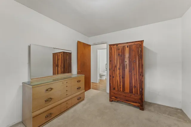 a bedroom with a bed and a dresser