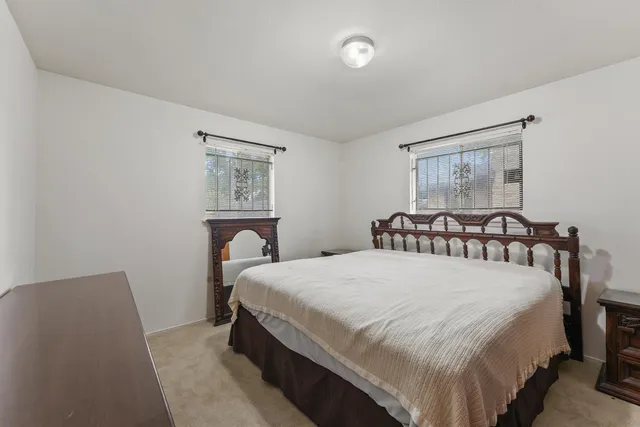 a bedroom with a bed and a painting on the wall