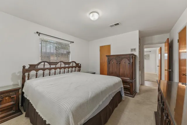 a bedroom with a bed and a ceiling fan