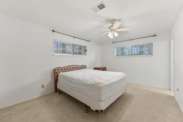 a spacious bathroom with a double vanity sink a mirror and a bathtub