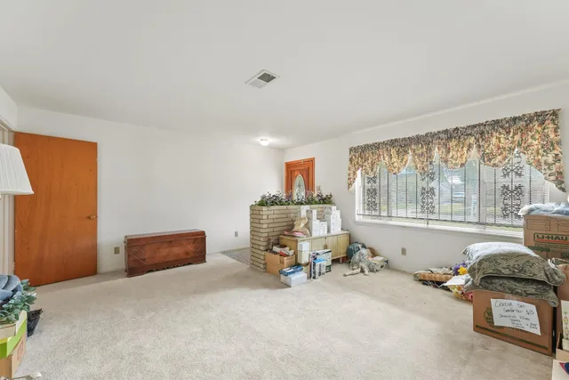 an empty room with furniture and chandelier