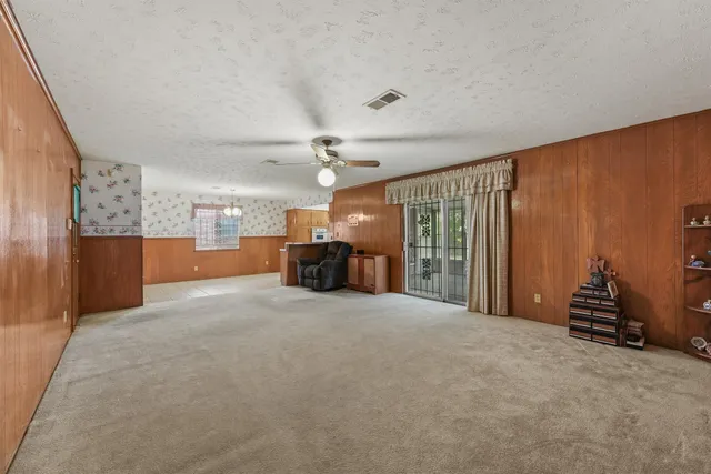 a view of an empty room with a kitchen