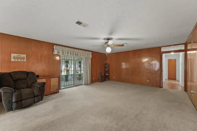 a large kitchen with stainless steel appliances granite countertop a sink refrigerator and microwave