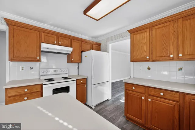 a kitchen with stainless steel appliances granite countertop a refrigerator a sink dishwasher and a stove
