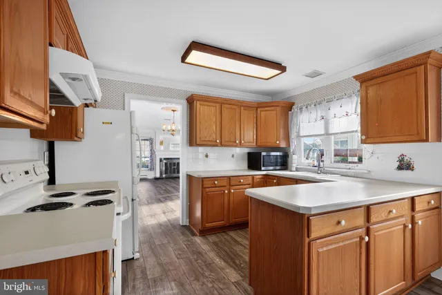 a kitchen with a sink stove and wooden cabinets