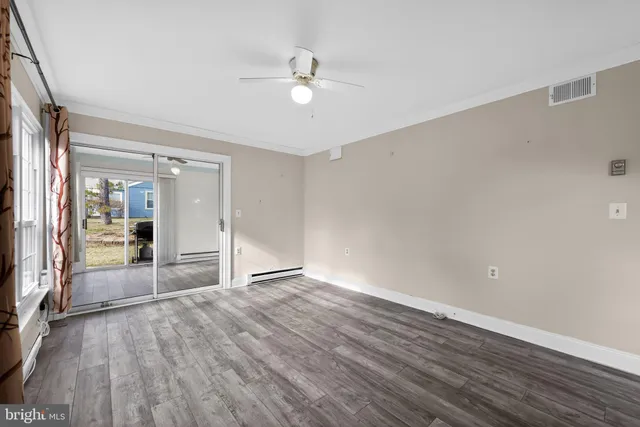 wooden floor in an empty room with a window