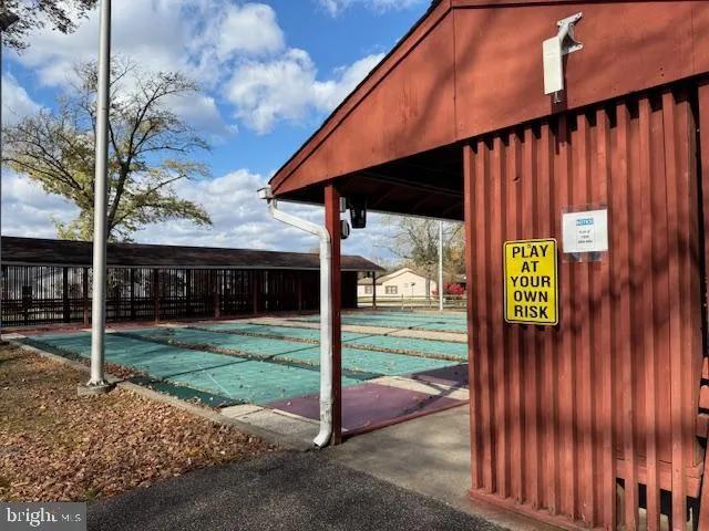 a view of a backyard with wooden fence